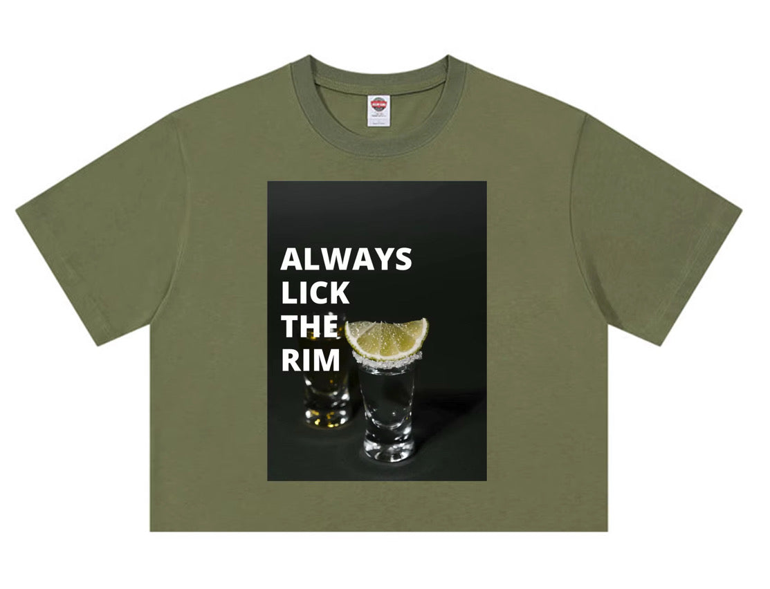 Olive green t-shirt with “Always Lick the Rim” text and tequila shot glasses graphic.