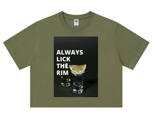 Olive green t-shirt with “Always Lick the Rim” text and tequila shot glasses graphic.